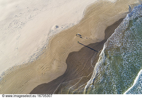 Aerial abstract view of Valencia beach with waves and wet sand