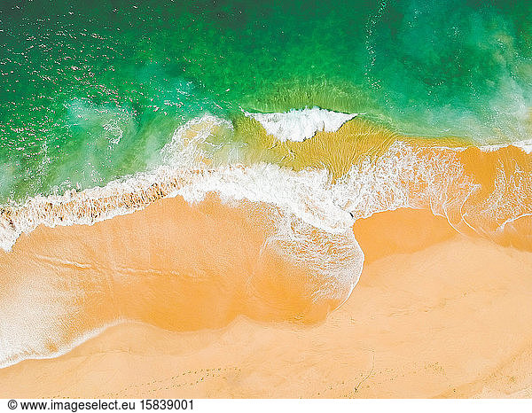 Aerial Drone Shot of ocean and sandy beach Green Torquoise