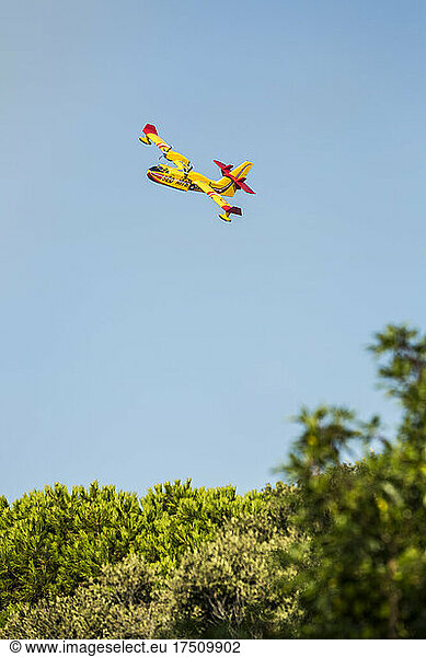 Aerial fire fighting aircraft coming down to pick up water  Corsica  France