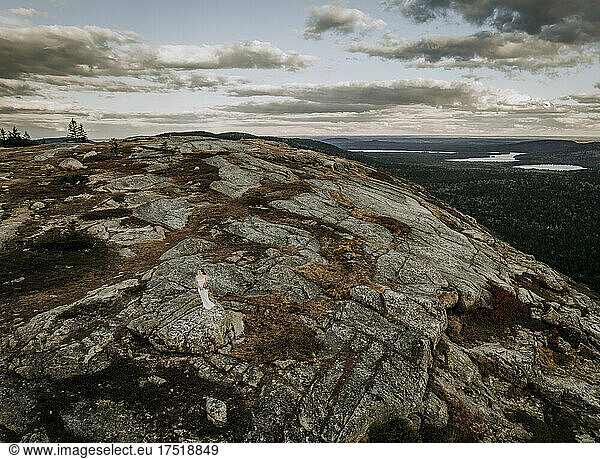 aerial of bride in white wedding dress on mountaintop  Maine