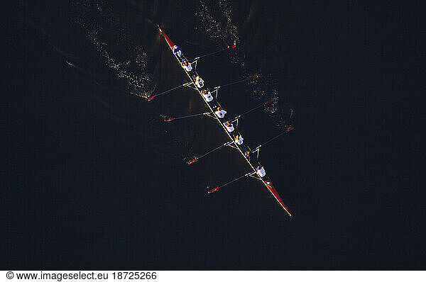 Aerial of sculling team rowing.