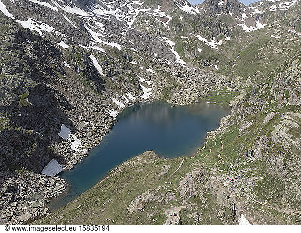 Aerial photo of an alpine glacial lake high in the Swiss mountains