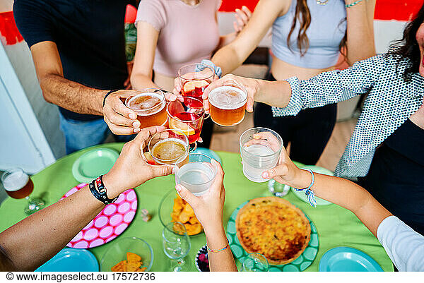 Aerial shot of unrecognizable Friends Toasting At Outdoor Party