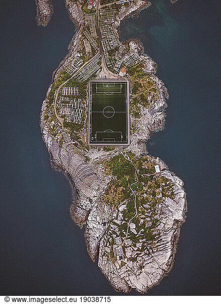 Aerial top view of a soccer field located in an island