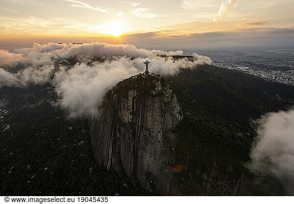 Aerial view from helicopter to Christ the Redeemer statue on mountain