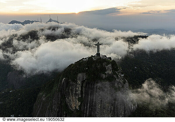 Aerial view from helicopter to Christ the Redeemer statue on mountain