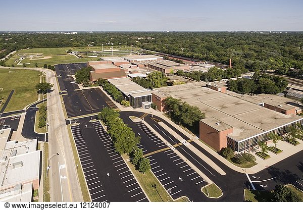 Aerial view of a high school with parking lot and ballfields in a suburban setting in Northbrook  IL. USA.