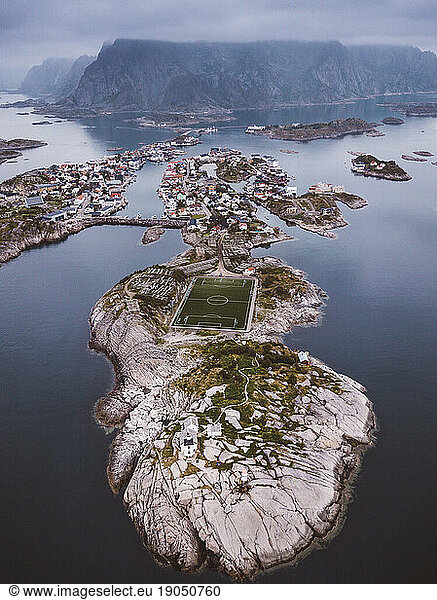 Aerial view of a soccer field and a city in islands