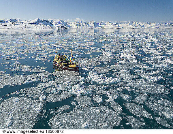 aerial view of a wooden boat caught in the ice