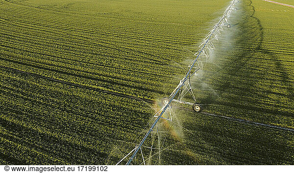 Aerial view of agricultural sprinkler spraying field