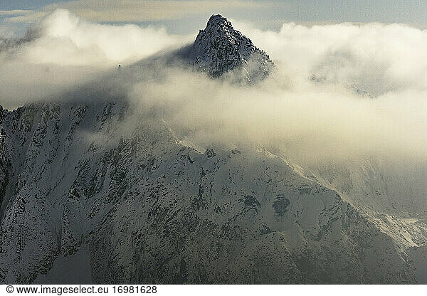 Aerial view of Avalanche Spire hiding in the clouds at sunset