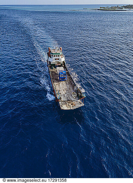 Aerial view of barge transporting single truck