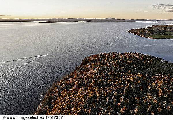 Aerial view of boat sailing along Penobscot bay  Maine at sunset