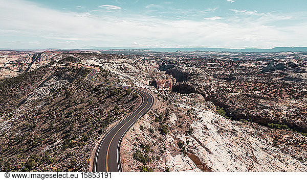 aerial view of country road winding through canyon landscape