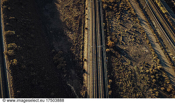 Aerial view of countryside train tracks at autumn dusk