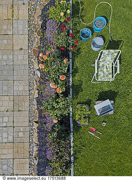 Aerial view of garden with chair and laptop
