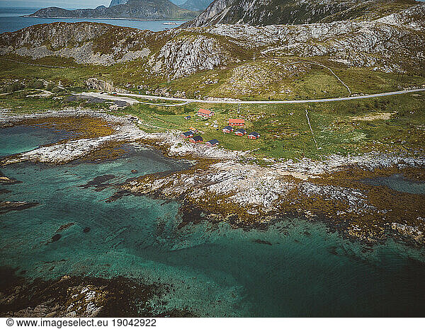 Aerial view of houses  the coast line  road and a car