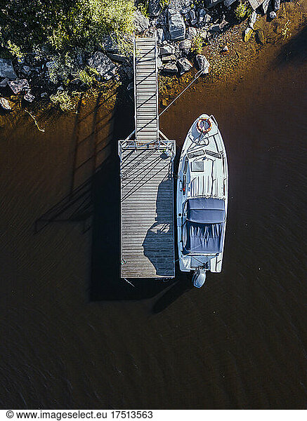 Aerial view of motorboat moored at brown shore of Lake Ladoga
