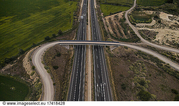 Aerial view of overpass stretching over countryside highway