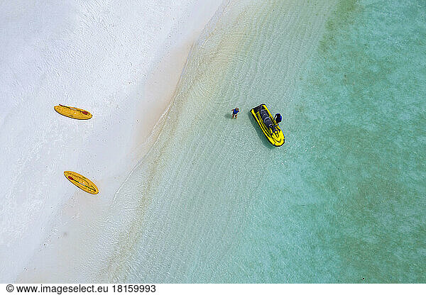 Aerial View of people and jetski at the beach  Maldives
