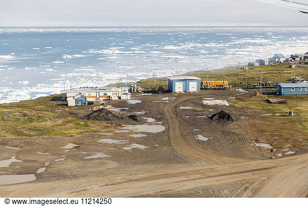 Aerial view of roads and coastal housing in Barrow  Sea Ice floating on the Arctic Ocean in the Background  Barrow  Arctic Alaska  USA  Summer