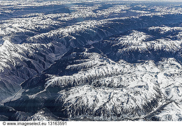 Aerial view of snow covered mountain ranges  Western China  East Asia