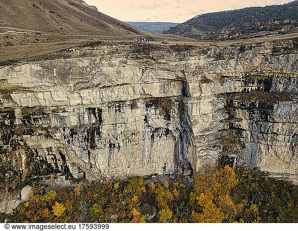 Aerial view of steep mountain cliff inÂ autumn