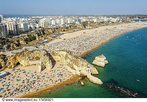 Aerial view of touristic Portimao with wide sandy beach Rocha full of people  Algarve  Portugal  Europe