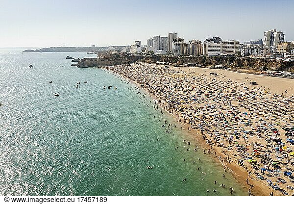 Aerial view of touristic Portimao with wide sandy beach Rocha full of people  Algarve  Portugal  Europe