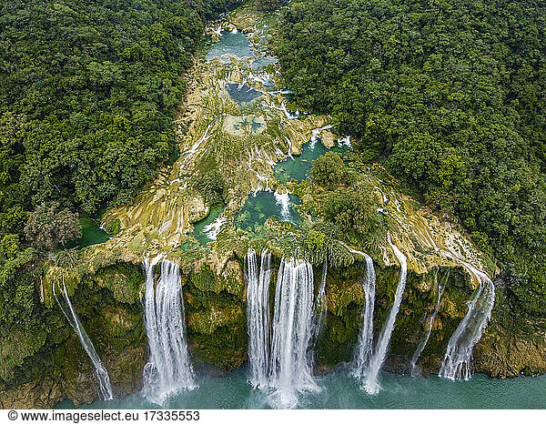 Aerial view of waterfall from rock formation amidst green trees  Huasteca Potosi  Mexico