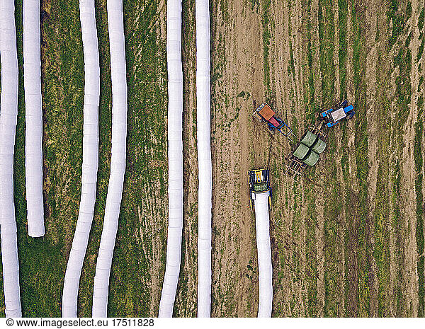 Aerial view of wrapped hay bales drying in field