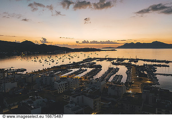 AERIAL View over Golden Sunset in Harbor Bay with Boats in Spain
