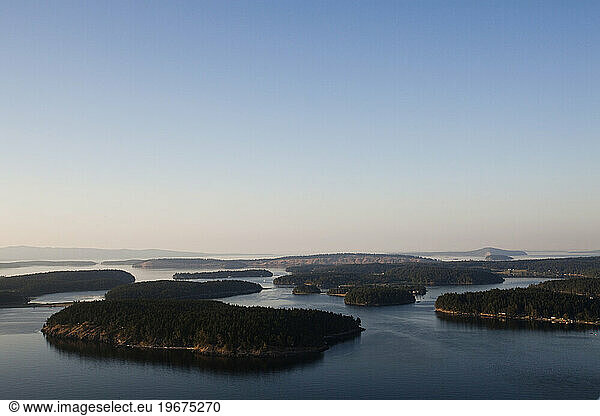 Aerial views of the many islands off the coast of Washington State at dusk.