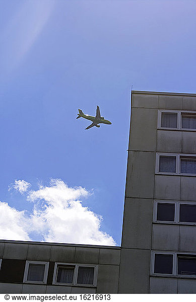 Aeroplane flying over house  low angle view