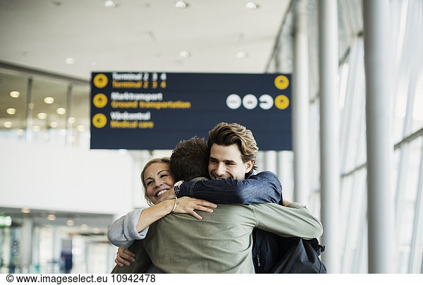 Affectionate business colleagues embracing at airport