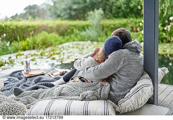 Affectionate couple cuddling on luxury patio