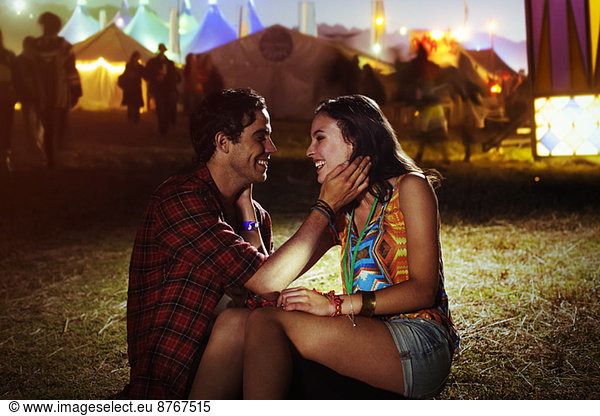 Affectionate couple outside music festival