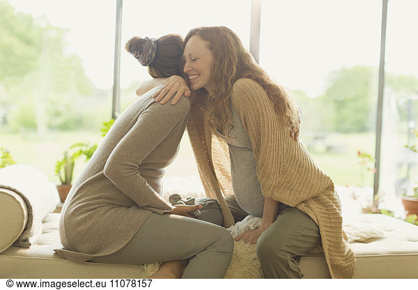 Affectionate pregnant women hugging