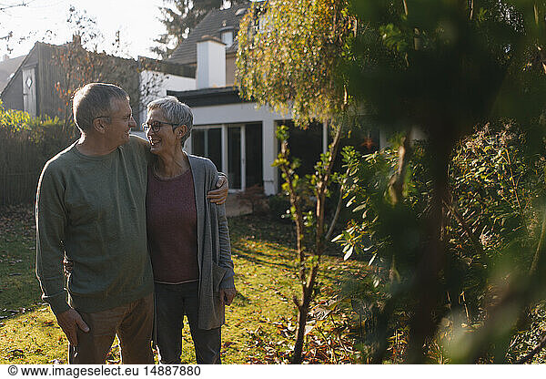 Affectionate senior couple embracing in garden