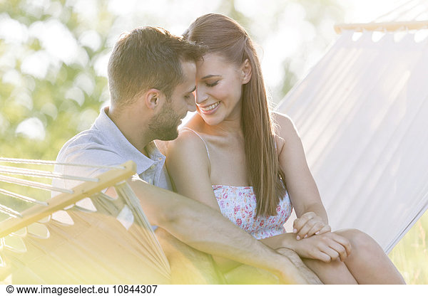 Affectionate young couple in summer hammock