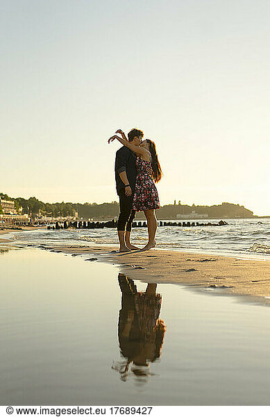 Affectionate young couple kissing each other at beach