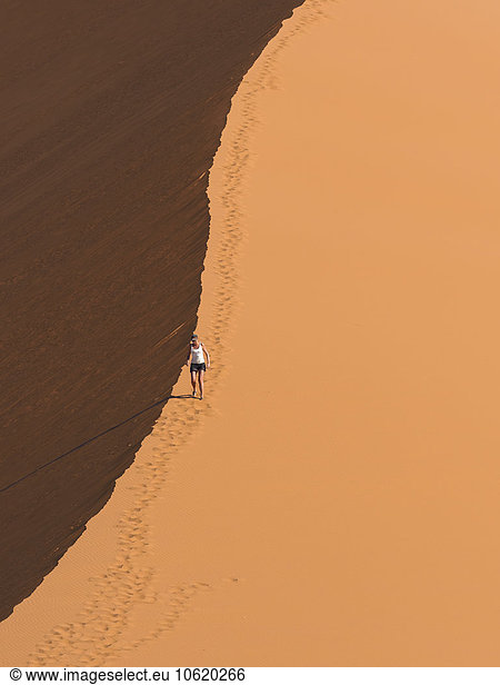 Africa  Namibia  Sossusvlei  woman hiking in the sand dune