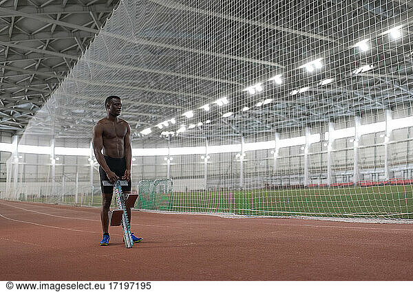 African American athlete preparing starting block