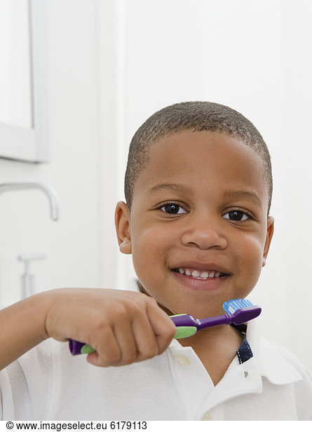 African American boy brushing teeth