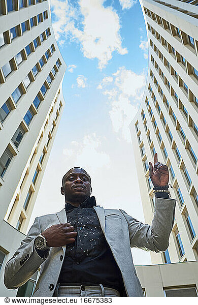 African American businessman between buildings