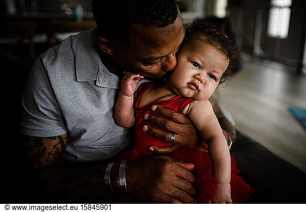 African American Dad Holding Mixed Race Daughter