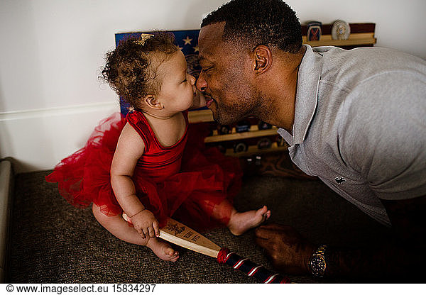 African American Dad Rubbing Noses with Biracial Daughter