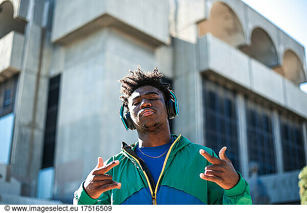 African American man with headphones. Gesturing with his hands.