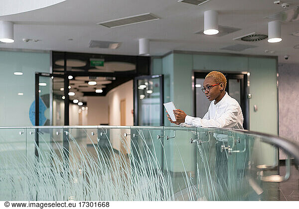 African American manager browsing tablet during break