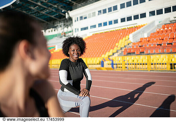 African American sportswoman lunging near friend